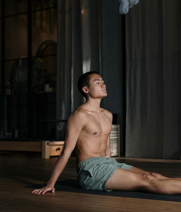 Man performing a controlled strength exercise in a calm, modern environment.