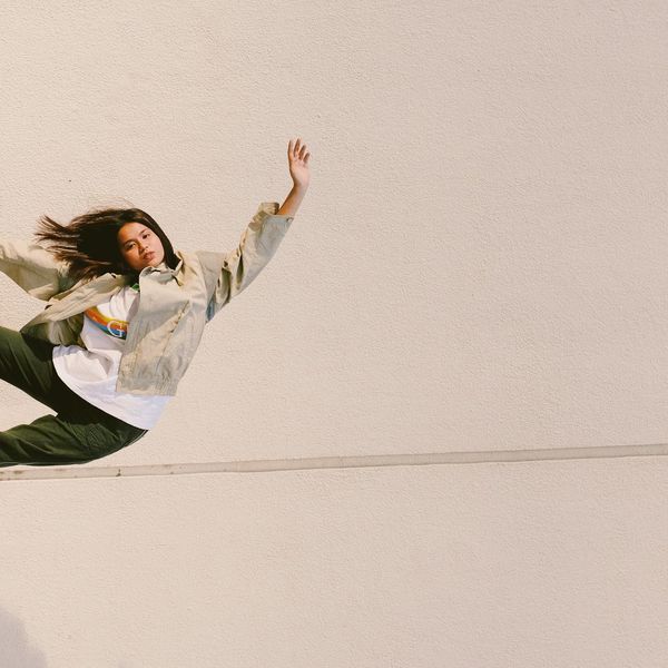 Silhouette of a person in a powerful pose against a minimalist background.